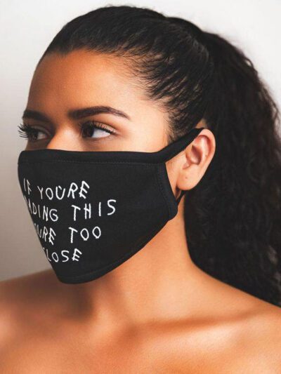 Close-up: Black fabric face mask with custom print. Soft, textured material, clean stitching. Daily use, unisex design. - Vie