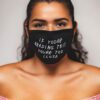 Close-up: Black fabric face mask with custom print. Soft, textured material, clean stitching. Daily use, unisex design. - Vie