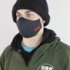 Close-up of a black face mask. Woven label detail. Finely stitched, durable fabric texture. Washable, reusable cloth face cov