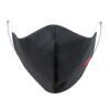 Close-up of a black face mask. Woven label detail. Finely stitched, durable fabric texture. Washable, reusable cloth face cov