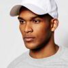 Close-up of a blank polo cap in a light color. Notice the fine pique knit fabric texture and reinforced stitching details at