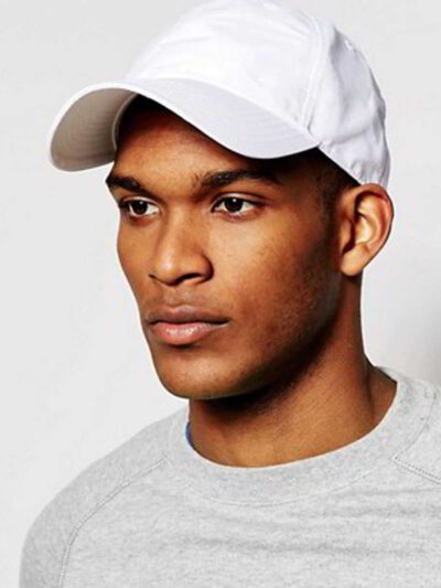 Close-up of a blank polo cap in a light color. Notice the fine pique knit fabric texture and reinforced stitching details at