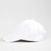 Close-up of a blank polo cap in a light color. Notice the fine pique knit fabric texture and reinforced stitching details at