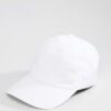 Close-up of a blank polo cap in a light color. Notice the fine pique knit fabric texture and reinforced stitching details at