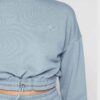 Woman in athletic tracksuit: heathered grey, comfy fit. Note the elastic cuffs, drawstring waist, and clean stitching. Active