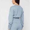 Woman in athletic tracksuit: heathered grey, comfy fit. Note the elastic cuffs, drawstring waist, and clean stitching. Active