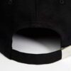 Close-up of a lightweight running cap. Notice the breathable mesh weave and reinforced stitching. Light grey color with subtl