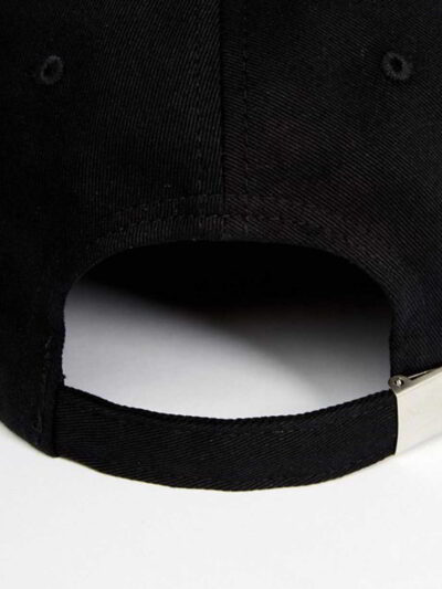 Close-up of a lightweight running cap. Notice the breathable mesh weave and reinforced stitching. Light grey color with subtl