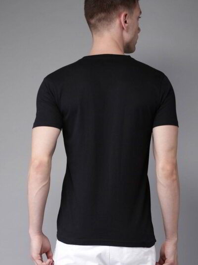 Folded stack of cotton tees. Assorted vibrant prints visible. Fine knit texture, even stitching. Short sleeve shirts, ready t