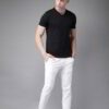 Folded stack of cotton tees. Assorted vibrant prints visible. Fine knit texture, even stitching. Short sleeve shirts, ready t