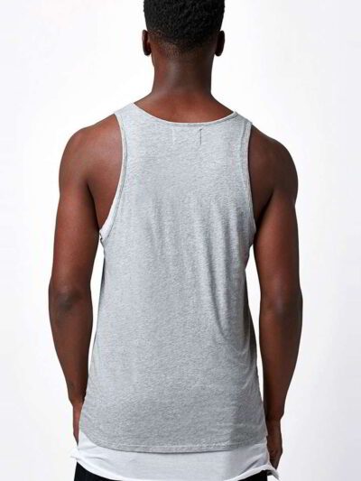 Close-up of bulk cotton tank tops showing soft, breathable knit fabric. Fine stitching detail, ideal for layering or summer w