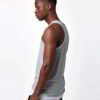 Close-up of bulk cotton tank tops showing soft, breathable knit fabric. Fine stitching detail, ideal for layering or summer w