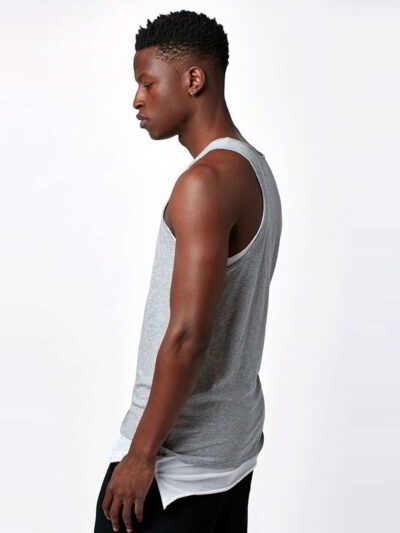 Close-up of bulk cotton tank tops showing soft, breathable knit fabric. Fine stitching detail, ideal for layering or summer w