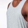 Close-up of bulk cotton tank tops showing soft, breathable knit fabric. Fine stitching detail, ideal for layering or summer w