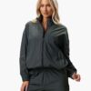 Women's velour tracksuit set, custom embroidered. Soft, plush cotton texture. Note delicate stitching detail on the jacket an
