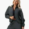 Women's velour tracksuit set, custom embroidered. Soft, plush cotton texture. Note delicate stitching detail on the jacket an