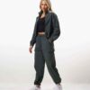 Women's velour tracksuit set, custom embroidered. Soft, plush cotton texture. Note delicate stitching detail on the jacket an