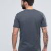 Close-up of custom printed apparel. Soft cotton blend, fine stitching, vibrant graphic. Crew neck tee hints of navy, exceptio