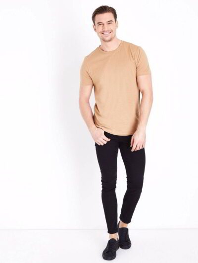 Close-up of folded bulk eco friendly t-shirts, showing soft texture, clean stitching. Neutral color palette, short sleeves. -
