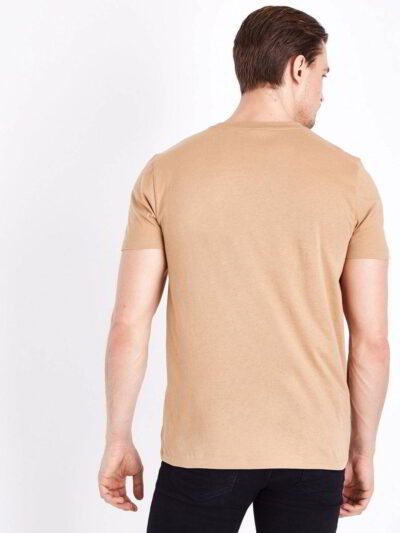 Close-up of folded bulk eco friendly t-shirts, showing soft texture, clean stitching. Neutral color palette, short sleeves. -