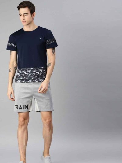Heavyweight shorts, roomy fit. Textured fabric, robust stitching detail. Urban street style, likely cotton blend. Dark color,