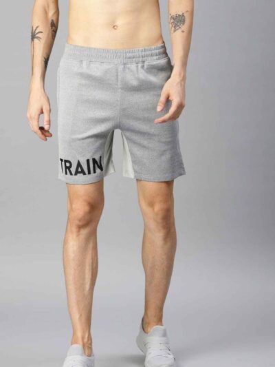 Heavyweight shorts, roomy fit. Textured fabric, robust stitching detail. Urban street style, likely cotton blend. Dark color,
