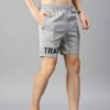 Heavyweight shorts, roomy fit. Textured fabric, robust stitching detail. Urban street style, likely cotton blend. Dark color,