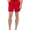 Lightweight summer beach shorts in a vibrant coral hue. Fine stitching detail shows durable construction. Soft, textured fabr