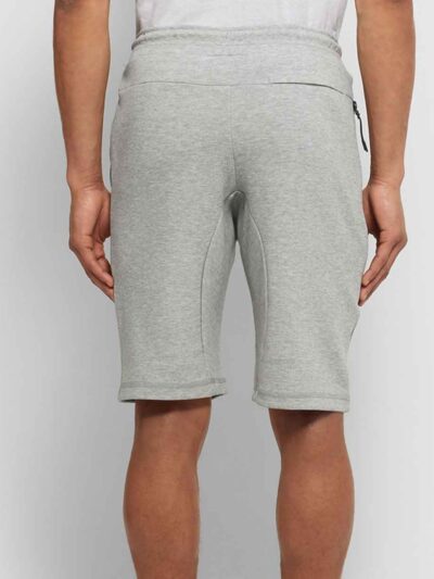 Close-up of black athletic gym shorts showing high-stretch fabric, durable stitching, and breathable texture. Designed for pe