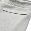 Close-up of black athletic gym shorts showing high-stretch fabric, durable stitching, and breathable texture. Designed for pe