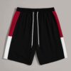 Close-up of athletic training shorts. Performance fabric with subtle texture, reinforced stitching. Breathable, moisture-wick