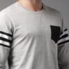 Pile of vibrant college t-shirts: soft cotton feel, durable stitching. Mix of classic crewneck & modern v-neck styles. Great
