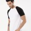 Stack of vibrant custom t-shirts, close-up. Soft cotton texture, neat seams. Short-sleeve crew necks, various colors visible.