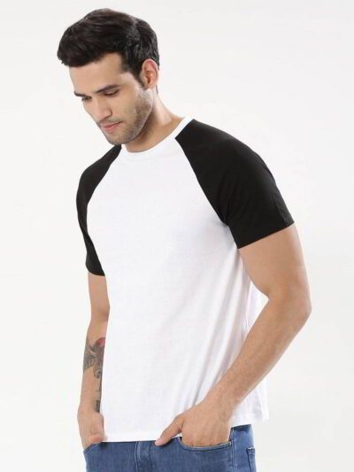 Stack of vibrant custom t-shirts, close-up. Soft cotton texture, neat seams. Short-sleeve crew necks, various colors visible.