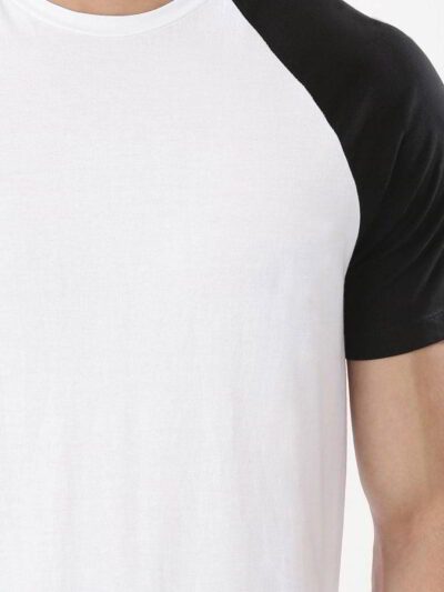 Stack of vibrant custom t-shirts, close-up. Soft cotton texture, neat seams. Short-sleeve crew necks, various colors visible.