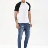Stack of vibrant custom t-shirts, close-up. Soft cotton texture, neat seams. Short-sleeve crew necks, various colors visible.