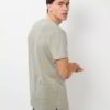 Close-up of custom team shirts. Soft, heathered gray fabric, crisp screen-printed logo, durable double-needle stitching on cr