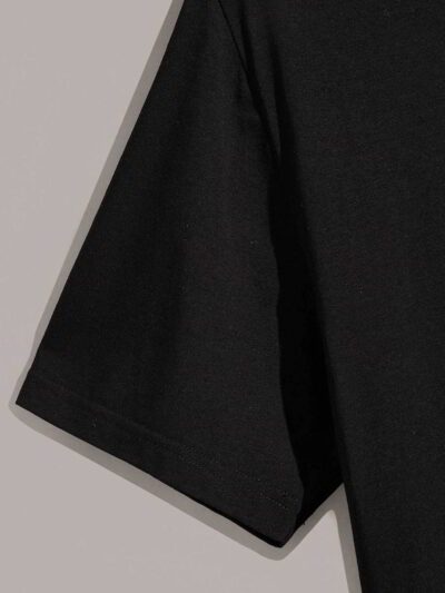 Close-up of bulk t-shirts. Soft cotton texture, neat stitching. Round neck, vibrant colors hints, ready for print. - View 4 o