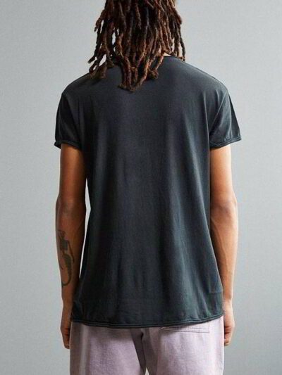 Stack of premium blank t-shirts in various muted colors, close-up showing fine-gauge knit fabric and durable double-needle st