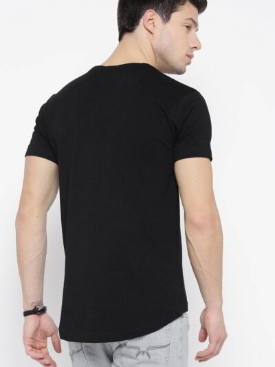 Close-up of neatly stacked tees. Soft cotton blend fabric, clean seams. Solid color assortment; hints of gray, navy, black. B