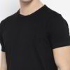 Close-up of neatly stacked tees. Soft cotton blend fabric, clean seams. Solid color assortment; hints of gray, navy, black. B