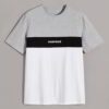 Stack of folded t-shirts, smooth cotton blend, close-stitched seams. Essential crew neck tees in solid colors, ready for reta