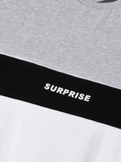 Stack of folded t-shirts, smooth cotton blend, close-stitched seams. Essential crew neck tees in solid colors, ready for reta