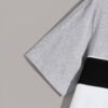 Stack of folded t-shirts, smooth cotton blend, close-stitched seams. Essential crew neck tees in solid colors, ready for reta