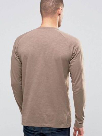 Close-up on a stack of vibrant, custom-printed tees. Notice the tight knit of the durable cotton and reinforced shoulder stit