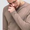 Close-up on a stack of vibrant, custom-printed tees. Notice the tight knit of the durable cotton and reinforced shoulder stit