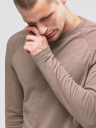 Close-up on a stack of vibrant, custom-printed tees. Notice the tight knit of the durable cotton and reinforced shoulder stit