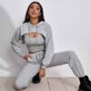 Women's fitness tracksuit and joggers set. Heather grey marl fabric, visible fine stitching. Soft, comfortable gym apparel.