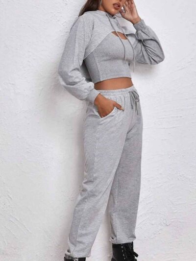 Women's fitness tracksuit and joggers set. Heather grey marl fabric, visible fine stitching. Soft, comfortable gym apparel.