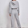 Women's fitness tracksuit and joggers set. Heather grey marl fabric, visible fine stitching. Soft, comfortable gym apparel.